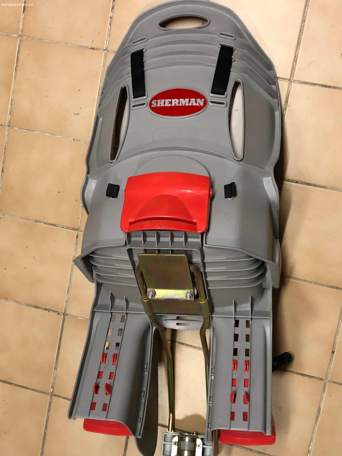 Cyklo sedačka Sherman. Daruji za odvoz, s neoriginálním držákem, původního držák byl odcizen s kolem, zůstala jen sedačka.