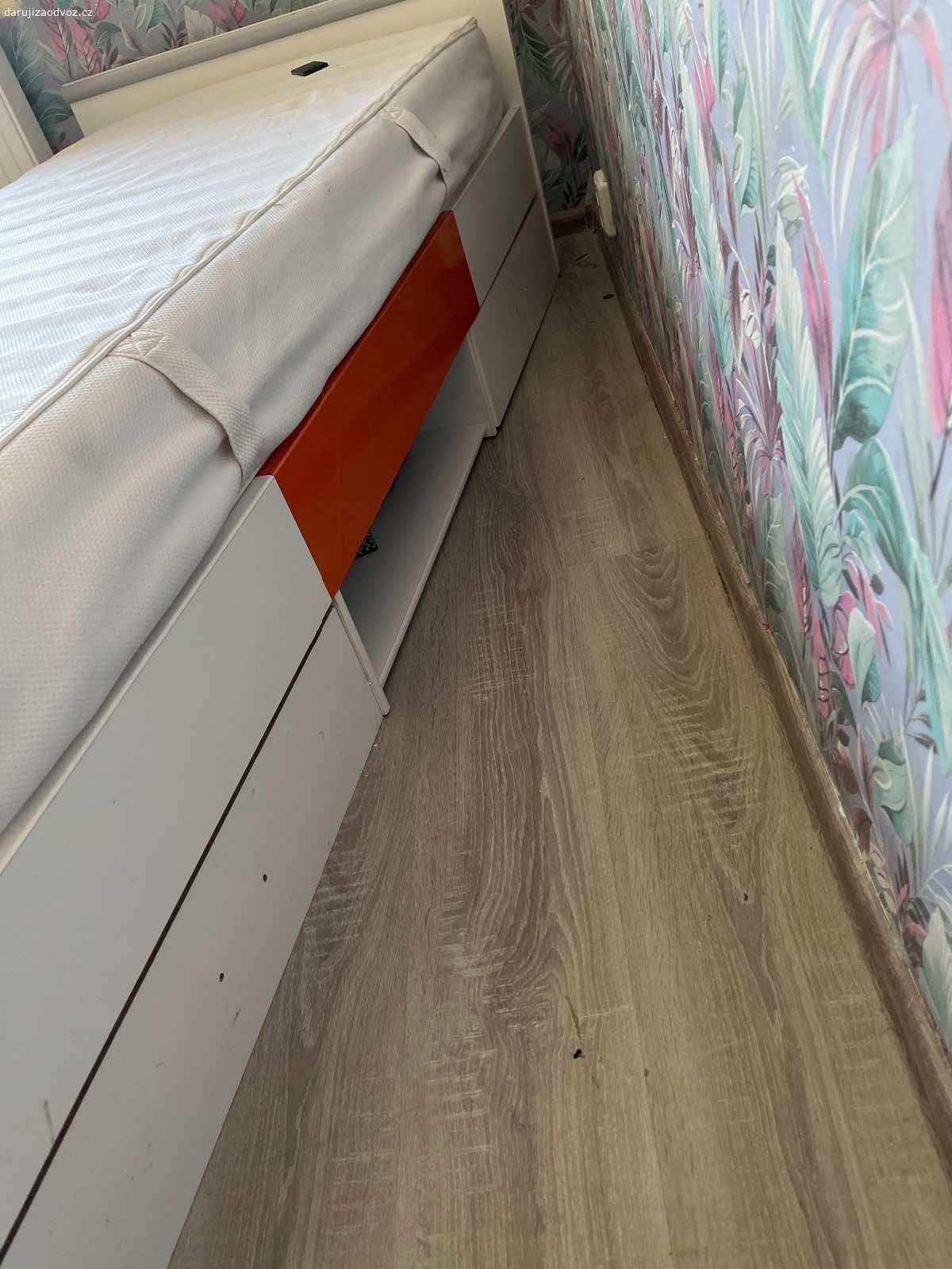 Daruji postel. Daruji postel s matrací, z boku jé prasklá, narychlo opravená, ale plně funkční